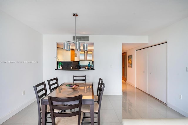 dining space featuring light tile patterned floors