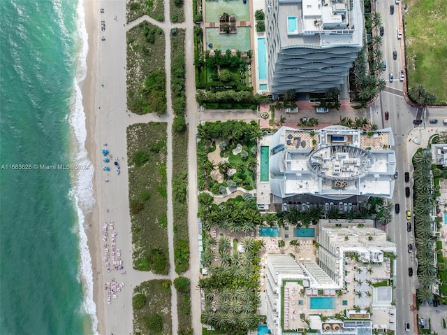 aerial view with a water view and a beach view