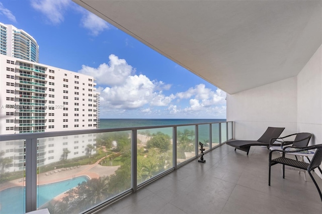 balcony with a water view and a beach view