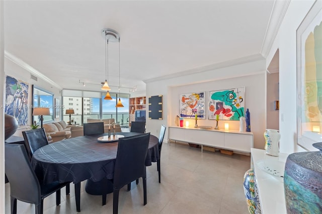 dining space with ornamental molding