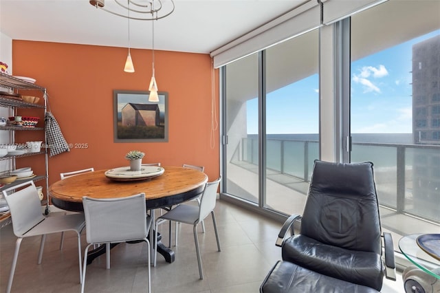 dining area with a water view and expansive windows