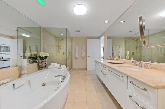 bathroom with tile patterned flooring, vanity, and shower with separate bathtub