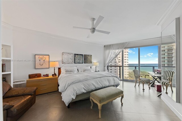 bedroom featuring ceiling fan, expansive windows, crown molding, and a water view