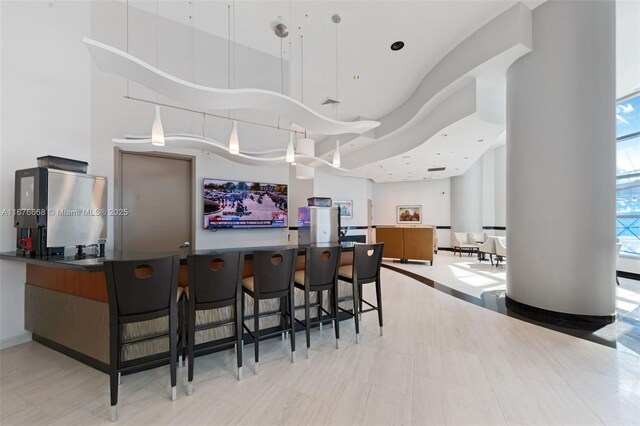 bar with a high ceiling and pendant lighting