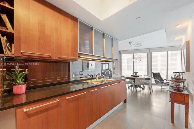 kitchen featuring dark stone countertops and sink