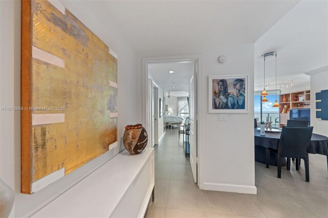 corridor featuring light tile patterned floors