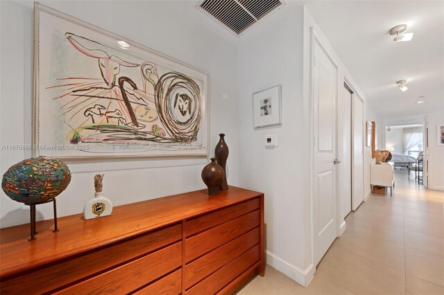 corridor with light tile patterned floors