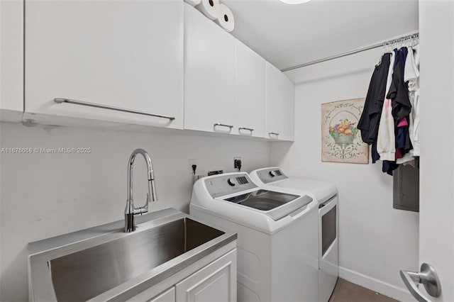 clothes washing area featuring cabinets, washer and clothes dryer, and sink