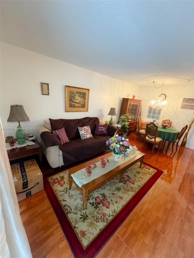 living room featuring a notable chandelier and wood-type flooring