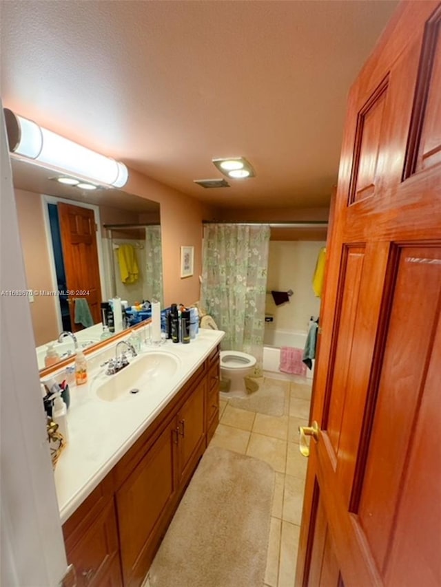 full bathroom featuring toilet, shower / bath combo, vanity, and tile patterned flooring