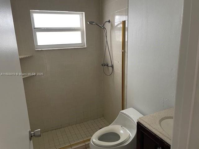 bathroom featuring tiled shower, vanity, and toilet