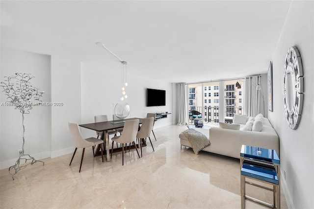 dining space featuring a wall of windows