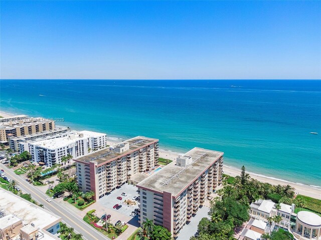 aerial view with a water view and a beach view