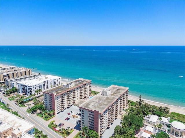 bird's eye view with a water view and a beach view