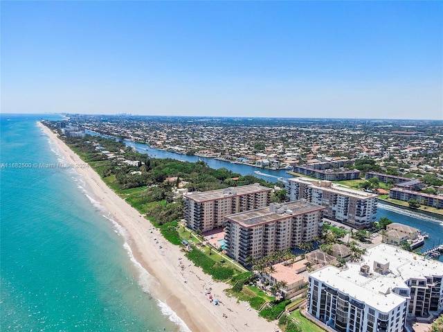 bird's eye view featuring a water view and a beach view