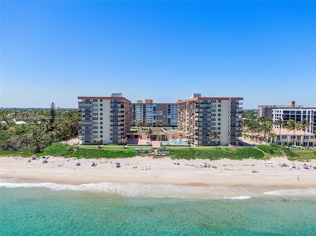 drone / aerial view with a water view and a beach view