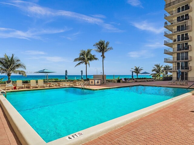 view of pool with a water view