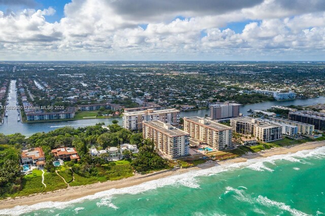 drone / aerial view featuring a water view and a beach view