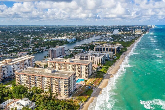 birds eye view of property with a water view and a view of the beach