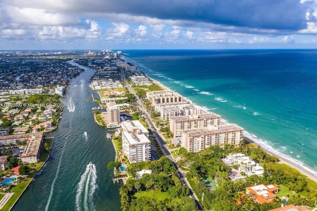 drone / aerial view featuring a water view and a view of the beach