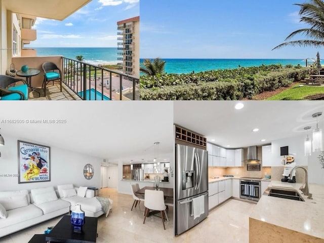 kitchen with white cabinetry, sink, hanging light fixtures, stainless steel appliances, and a water view