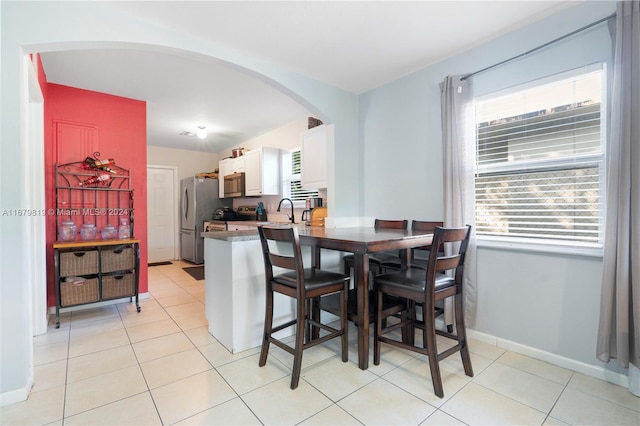 tiled dining area featuring sink