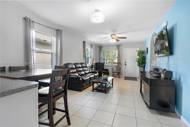 tiled living room featuring ceiling fan