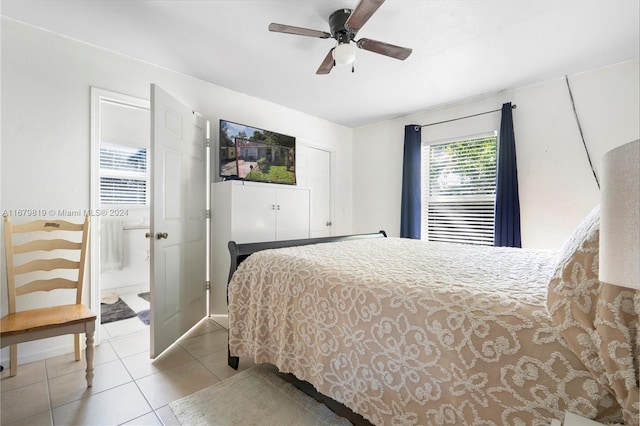 tiled bedroom with ensuite bathroom and ceiling fan