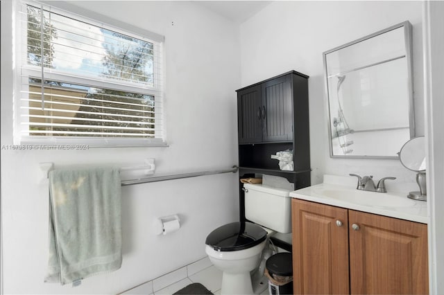 bathroom with vanity, walk in shower, toilet, and tile patterned floors