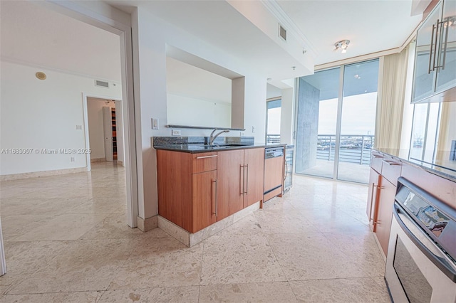 kitchen with sink, dishwasher, stainless steel oven, and expansive windows