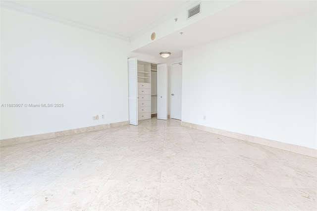 unfurnished room featuring ornamental molding