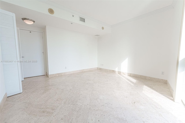 spare room featuring ornamental molding