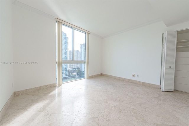 spare room featuring crown molding