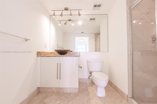 bathroom with toilet, walk in shower, and vanity