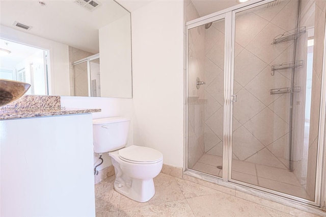 bathroom with toilet, a shower with door, and vanity