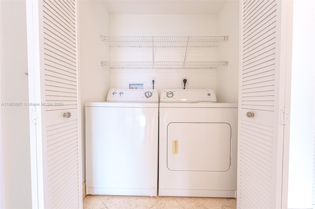 clothes washing area featuring washing machine and clothes dryer