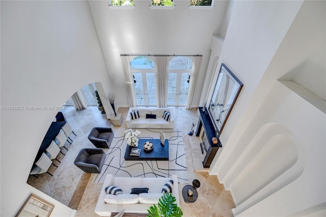 living room with a high ceiling and french doors