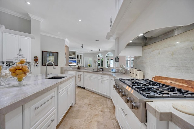 kitchen featuring stainless steel gas cooktop, sink, light stone counters, and white cabinets