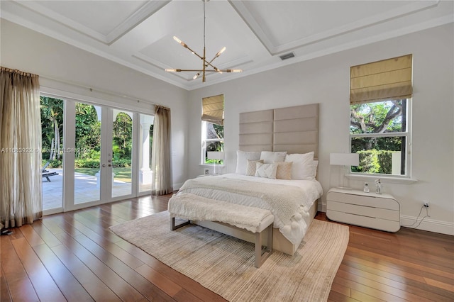 bedroom with french doors, access to exterior, hardwood / wood-style floors, coffered ceiling, and a notable chandelier