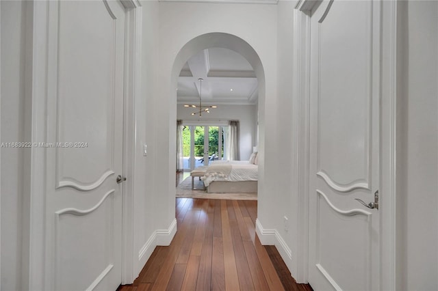 hallway featuring crown molding, beamed ceiling, and dark wood-type flooring