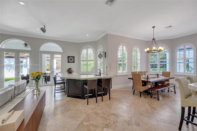 kitchen with french doors, a center island, plenty of natural light, and pendant lighting