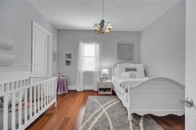 bedroom with a notable chandelier and hardwood / wood-style floors