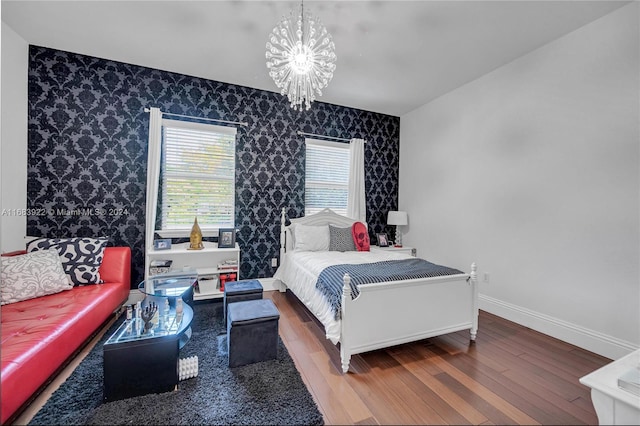 bedroom with hardwood / wood-style floors and a chandelier