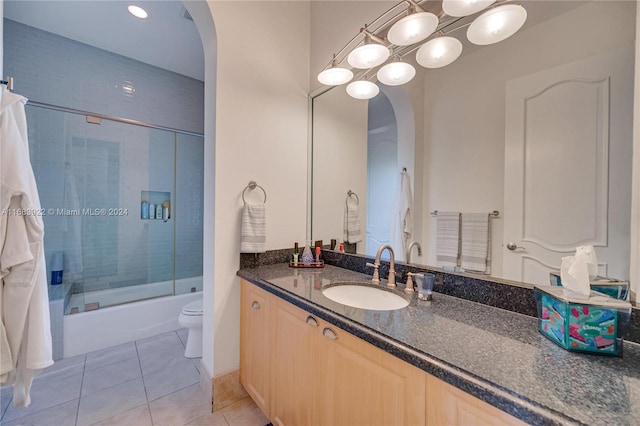 full bathroom with toilet, vanity, tile patterned floors, and shower / bath combination with glass door