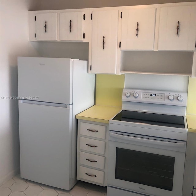 kitchen featuring white appliances and white cabinetry