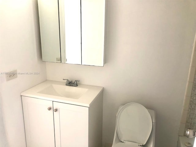 bathroom featuring vanity and toilet