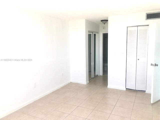 unfurnished bedroom featuring light tile patterned flooring