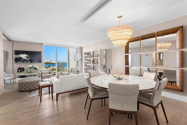 dining space with a notable chandelier, wood-type flooring, and floor to ceiling windows