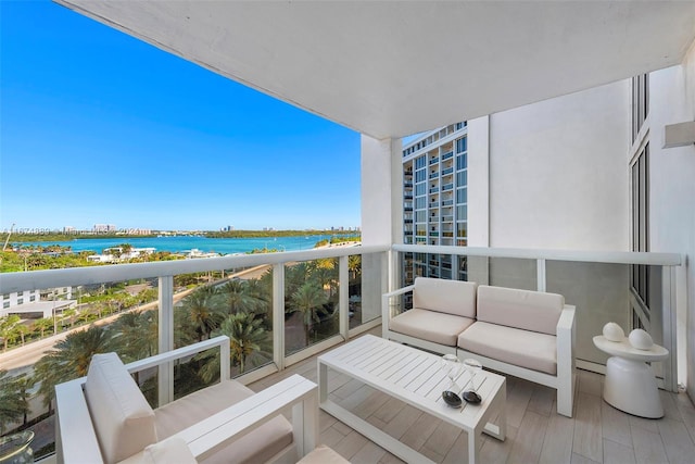 balcony with a baseboard heating unit and a water view