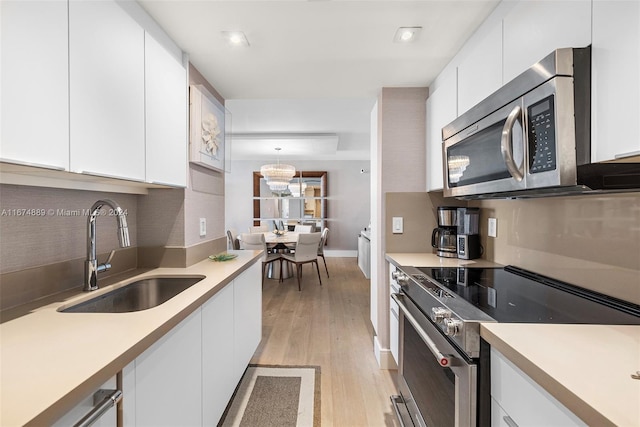 kitchen featuring white cabinetry, appliances with stainless steel finishes, and sink